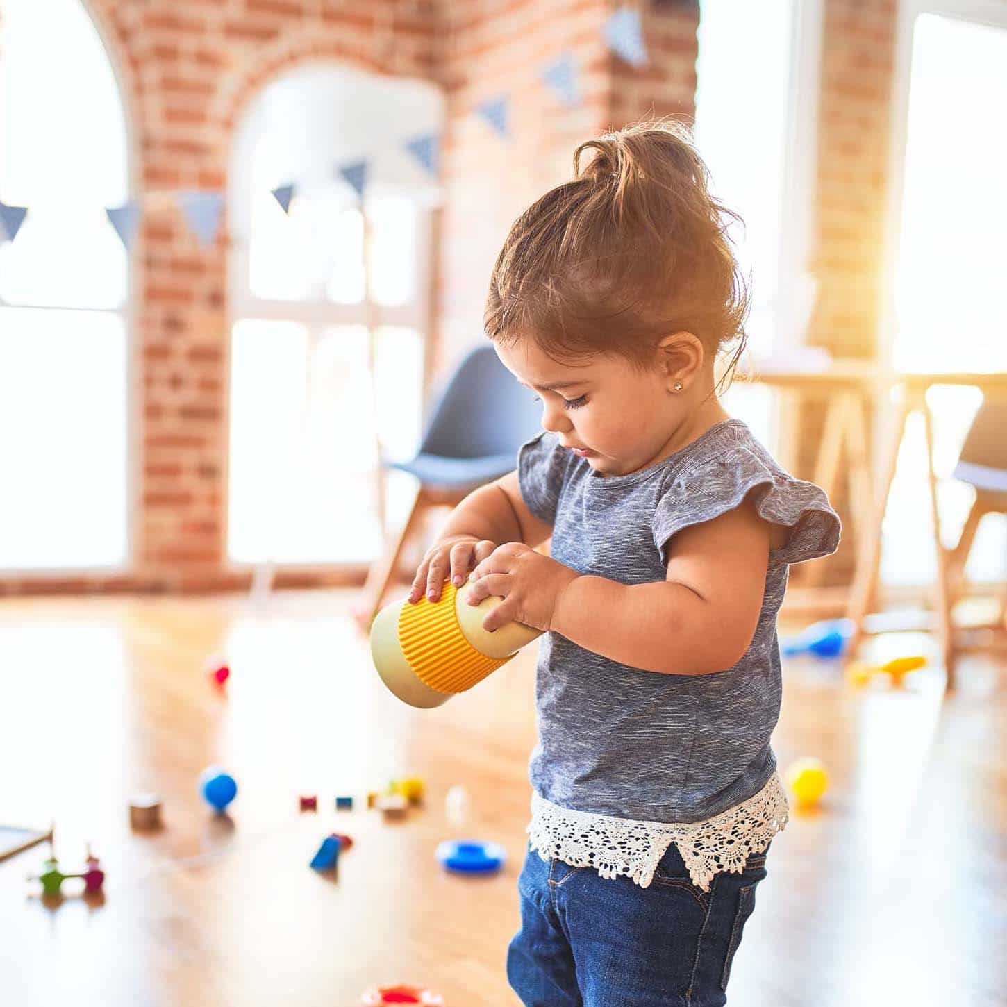child playing with a cup